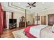 Spacious main bedroom featuring tray ceilings, hardwood floors and a four-post bed frame at 4133 Foxhound Dr, Clermont, FL 34711
