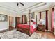 This serene main bedroom includes a four-poster bed, tray ceiling, and private ensuite bath at 4133 Foxhound Dr, Clermont, FL 34711