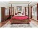 This inviting main bedroom has a four-poster bed, a walk-in closet and plenty of natural light at 4133 Foxhound Dr, Clermont, FL 34711