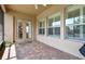 Charming screened patio with brick pavers providing a cozy transition between indoor and outdoor living spaces at 4133 Foxhound Dr, Clermont, FL 34711