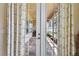 Elegant patio doors open to screened lanai with brick pavers and outdoor seating area at 4133 Foxhound Dr, Clermont, FL 34711