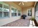 Covered patio featuring brick pavers, outdoor cooking area and plenty of natural light from the open windows at 4133 Foxhound Dr, Clermont, FL 34711