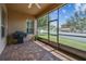 Relaxing screened patio with brick pavers, ceiling fan, and outdoor grill, perfect for entertaining guests at 4133 Foxhound Dr, Clermont, FL 34711