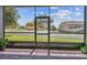 Open-air patio with screens offering seamless indoor-outdoor living with a green grassy view at 4133 Foxhound Dr, Clermont, FL 34711