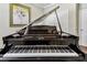 Close-up of a grand piano with keys, showcasing its craftsmanship and musical elegance at 4133 Foxhound Dr, Clermont, FL 34711