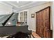 Stylish piano room with a grand piano, wooden floors, and a decorative cabinet at 4133 Foxhound Dr, Clermont, FL 34711