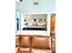 Living room bar with white cabinets, granite countertop, shelving, and drinkware at 4186 Buglers Rest Pl, Casselberry, FL 32707