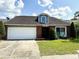 Charming single-story home with a two-car garage, brick facade, and well-manicured lawn at 4186 Buglers Rest Pl, Casselberry, FL 32707