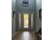 Bright foyer featuring a decorative glass front door, tile flooring, and elegant chandelier at 4186 Buglers Rest Pl, Casselberry, FL 32707