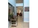 Hallway view showing light blue walls, tile floors, and living room beyond at 4186 Buglers Rest Pl, Casselberry, FL 32707