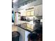 Bright kitchen with white cabinets, dark countertops, and stainless steel appliances at 4186 Buglers Rest Pl, Casselberry, FL 32707