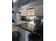 Bright kitchen with white cabinets, dark countertops, and stainless steel appliances at 4186 Buglers Rest Pl, Casselberry, FL 32707