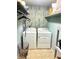 Efficient laundry room with modern appliances, shelving, and decor at 4186 Buglers Rest Pl, Casselberry, FL 32707