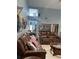 Spacious living room with high ceilings, comfortable leather seating, and views of the entry at 4186 Buglers Rest Pl, Casselberry, FL 32707