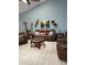 Comfortable living room with leather seating, tile floors, and a ceiling fan for added comfort at 4186 Buglers Rest Pl, Casselberry, FL 32707