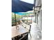 Screened patio featuring a dining table with umbrella, outdoor seating area, and shade sail at 4186 Buglers Rest Pl, Casselberry, FL 32707