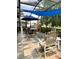 Enjoy outdoor dining on this screened in patio with tile floors, and a stylish blue shade covering at 4186 Buglers Rest Pl, Casselberry, FL 32707