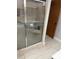 A shower stall with a glass door, neutral tile, and a built in shelf at 4186 Buglers Rest Pl, Casselberry, FL 32707