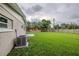 Large, green backyard featuring a well-maintained lawn and partial fencing, perfect for outdoor activities at 4200 Colony Way, Orlando, FL 32808