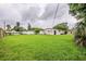 Expansive backyard with green grass, enclosed by fencing, providing privacy and space for various activities at 4200 Colony Way, Orlando, FL 32808