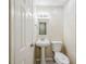 Bathroom featuring a toilet, sink with pedestal, mirror, and new floors at 4200 Colony Way, Orlando, FL 32808