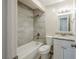 A clean bathroom featuring a tub and shower combo and granite vanity at 4200 Colony Way, Orlando, FL 32808