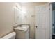 Bright bathroom with a granite vanity, mirror, and a door leading to other rooms at 4200 Colony Way, Orlando, FL 32808