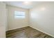 Cozy bedroom featuring wood-look floors and a bright window at 4200 Colony Way, Orlando, FL 32808