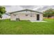 The home's rear exterior features a well-maintained lawn, neutral paint, and access door at 4200 Colony Way, Orlando, FL 32808