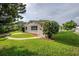 A cozy home with lush green lawn, neat landscaping, and a curved walkway to the front door at 4200 Colony Way, Orlando, FL 32808