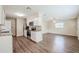 An open kitchen concept, stainless appliances, and wood-look flooring, seamless flow to the living room at 4200 Colony Way, Orlando, FL 32808