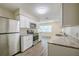 Updated kitchen featuring stainless appliances, granite countertops, and wood look floors at 4200 Colony Way, Orlando, FL 32808