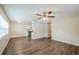Spacious living room featuring modern ceiling fan, wood-look floors and abundant natural light at 4200 Colony Way, Orlando, FL 32808