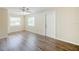 Spacious living room with natural light, wood-look floors and neutral paint at 4200 Colony Way, Orlando, FL 32808