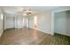 Spacious living room with wood-look floors, ceiling fan, closet and an attached bathroom at 4200 Colony Way, Orlando, FL 32808