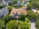 Beautiful aerial view of the mediterranean style estate with lush landscaping, pool, and clay tile roof at 4400 New Broad St, Orlando, FL 32814