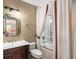 Classic bathroom features a vanity sink and a bathtub-shower with a patterned curtain at 4400 New Broad St, Orlando, FL 32814