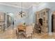 Stylish dining area with a round wooden table, upholstered chairs, and built-in desk with granite countertop at 4400 New Broad St, Orlando, FL 32814