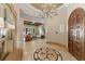 Grand foyer with decorative tile inlay, a chandelier, and an open view to the living area at 4400 New Broad St, Orlando, FL 32814