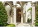 Inviting front entrance with a wreath, stone columns, and manicured greenery at 4400 New Broad St, Orlando, FL 32814