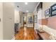 Wide hallway with hardwood floors, decorative lighting, and framed artwork at 4400 New Broad St, Orlando, FL 32814