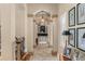 Elegant hallway with arched columns, a decorative chandelier, and framed artwork at 4400 New Broad St, Orlando, FL 32814