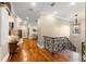 Elegant hallway with hardwood flooring, wrought iron railings, and decorative lighting at 4400 New Broad St, Orlando, FL 32814