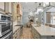 Gourmet kitchen with stainless steel appliances, custom cabinetry, and views to breakfast nook at 4400 New Broad St, Orlando, FL 32814