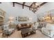 Inviting living room showcasing high ceilings with wooden beams and an open layout to the gourmet kitchen at 4400 New Broad St, Orlando, FL 32814