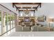 Bright living room featuring an entertainment center, high ceilings with wooden beams, and pool views at 4400 New Broad St, Orlando, FL 32814