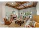 Cozy living room featuring a fireplace, coffered ceiling, and sliding glass doors to the patio at 4400 New Broad St, Orlando, FL 32814