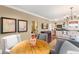 Comfortable living room with adjacent kitchen has hardwood floors and elegant decor at 4400 New Broad St, Orlando, FL 32814