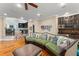 Open concept living room with hardwood floors and custom bar area in the background at 4400 New Broad St, Orlando, FL 32814