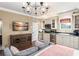 Living room with attached kitchen has a large TV and neutral walls at 4400 New Broad St, Orlando, FL 32814